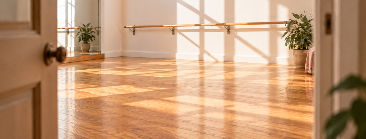 Warm Elite Dancer studio interior with timber floor, ballet barre and natural window light